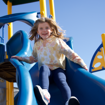 Elementary girl on slide